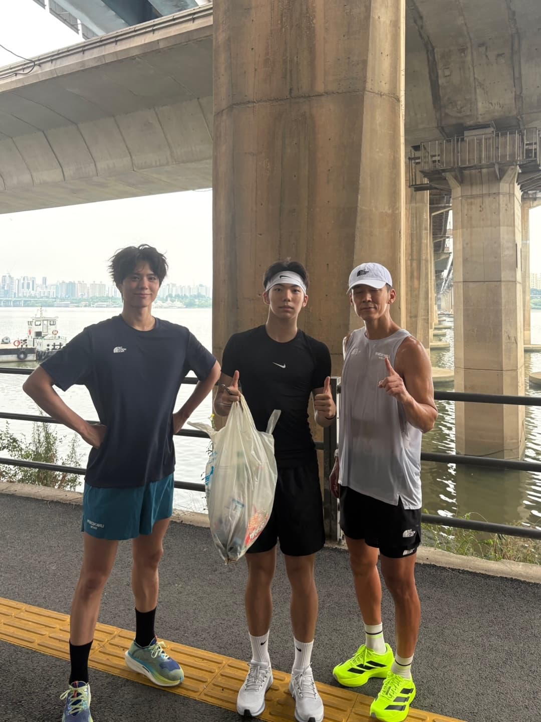 Mingun and friends plogging under a Han River bridge in Seoul